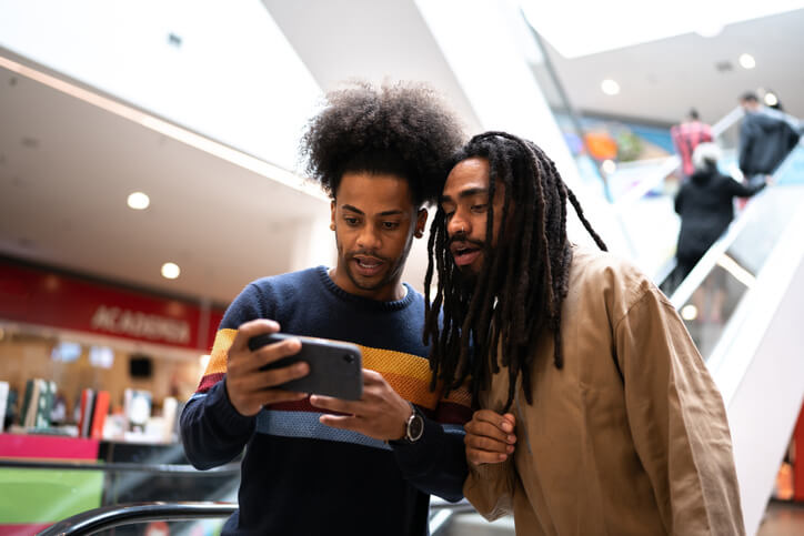 Two men watching a video on a phone