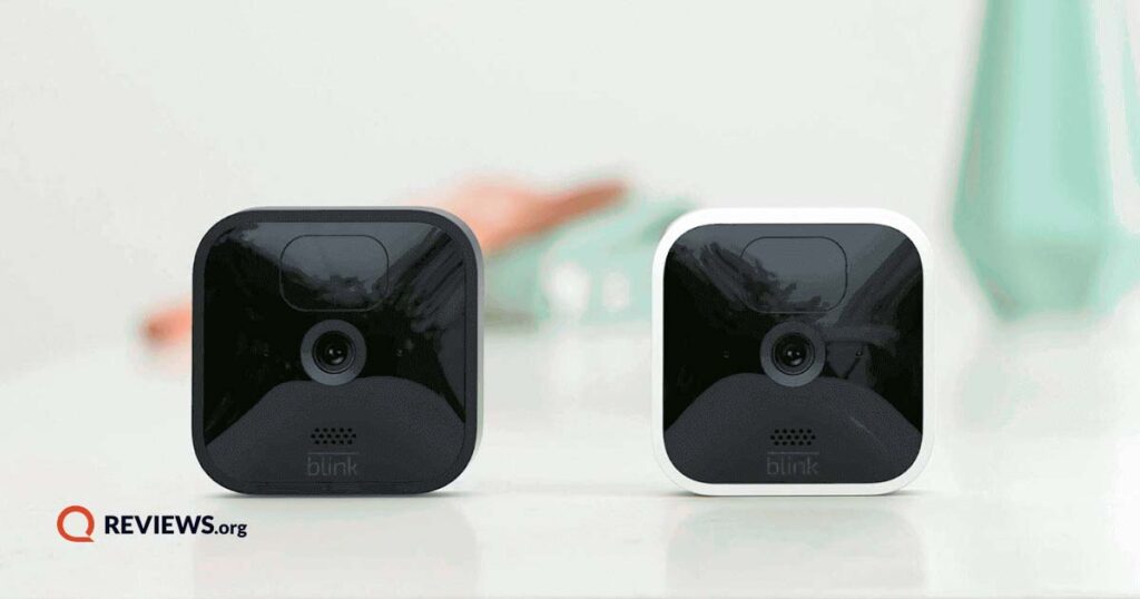 two blink cameras on a desk in a brightly lit room