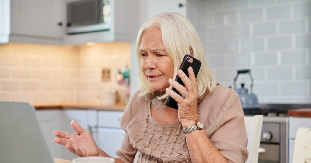 Frustrated older woman on the phone