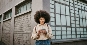 Shot of a beautiful young woman using her cellphone while out in the city