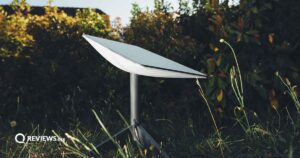 Starlink satellite pointing up to the sky from the grass