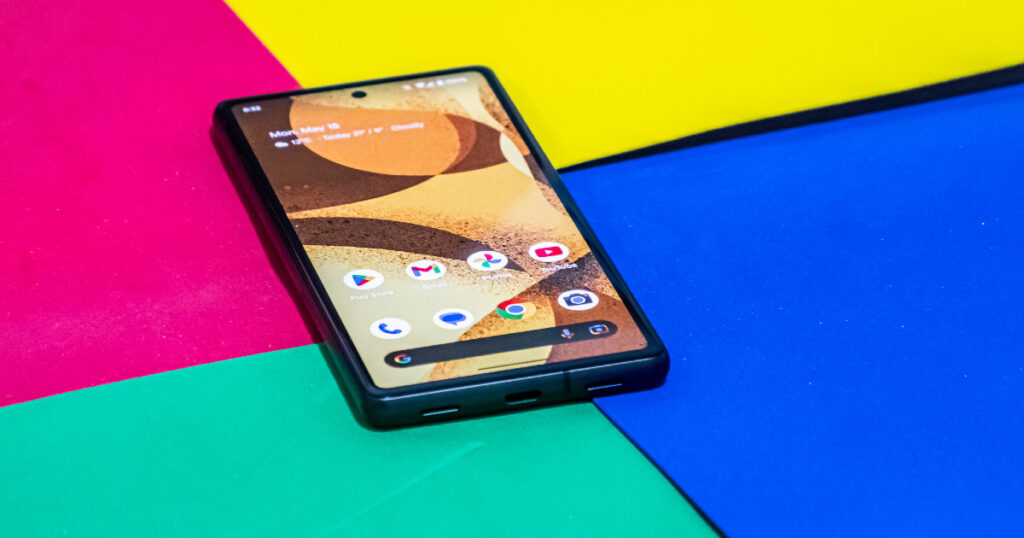 Google Pixel 7a lying on colored surface