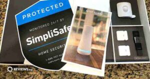 A box of SimpliSafe equipment shown open with the yard sign and user guide on top
