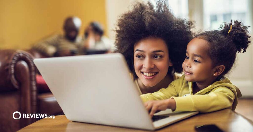 Black female and her daughter using a laptop together