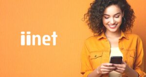 Photo of a woman using iiNet Mobile services on an orange background