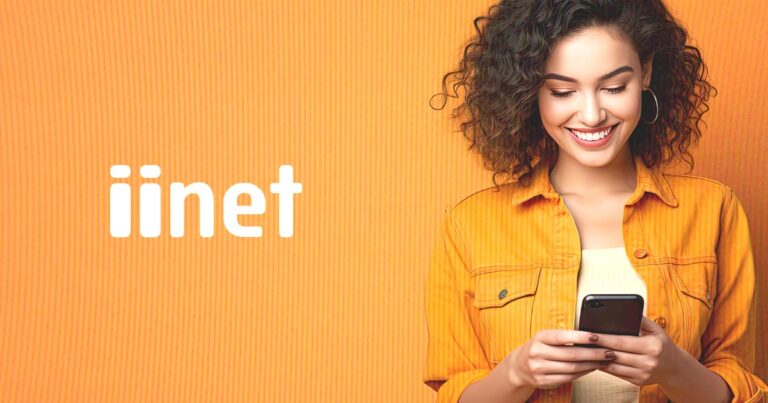 Photo of a woman using iiNet Mobile services on an orange background