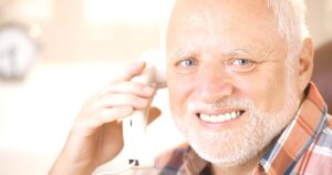 Senior man using a home phone.