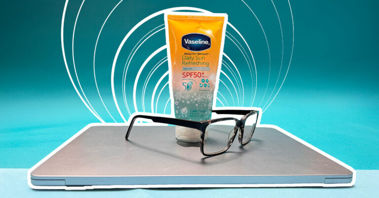 sunscreen on top of a laptop with a pair of glasses