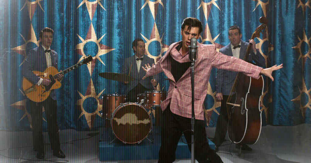 Screenshot from the 2022 movie Elvis featuring Austin Butler as Elvis Presley dancing in front of backup singers