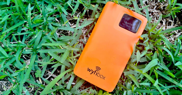 Photograph of the orange Wyfibox laying on the grass