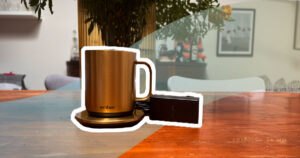 Ember Mug 2 in gold on a wooden table