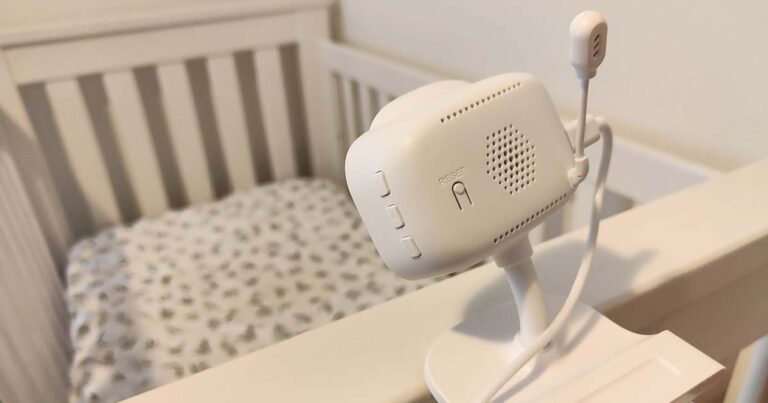 Photograph of the Uniden Baby Watch Smart Baby Video Camera/Monitor (BW6101R) mounted on a cot.