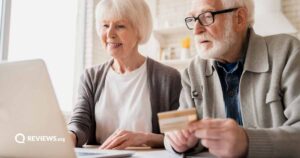 An elderly couple looking at a laptop screen