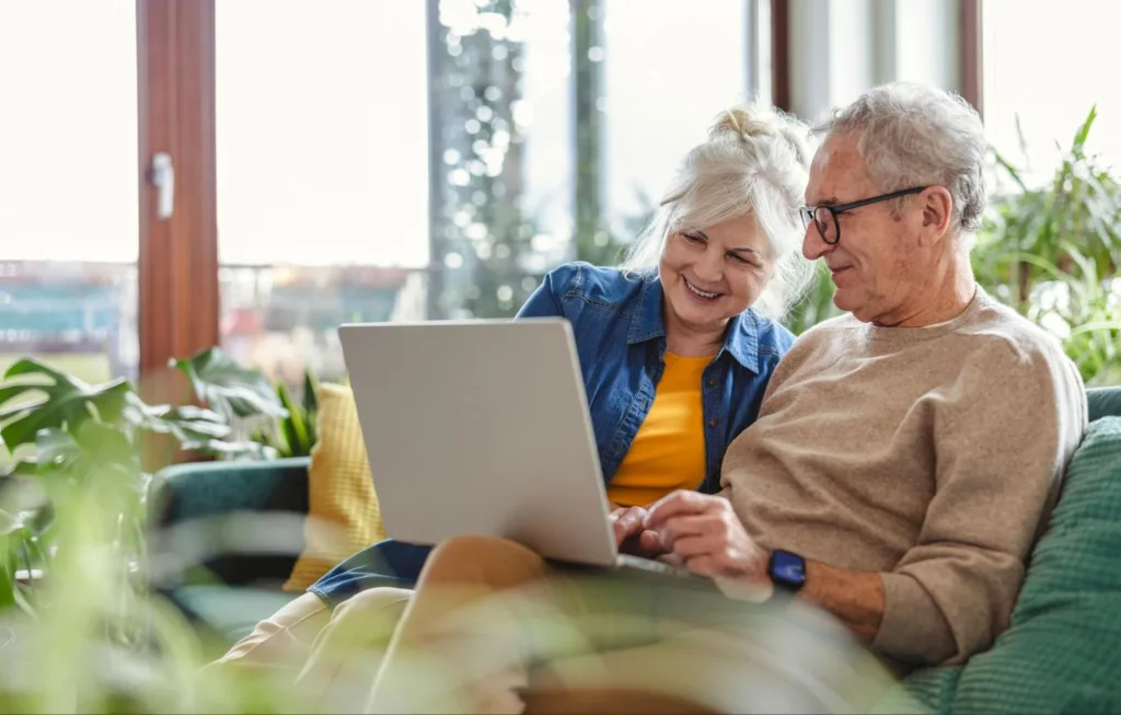 Senior couple looking at a laptop together
