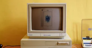 vintage home computer with iPhone SE on the screen