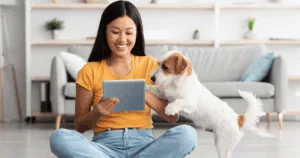 Woman and dog using tablet at home
