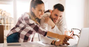 Young couple using a laptop to shop and compare internet plans.
