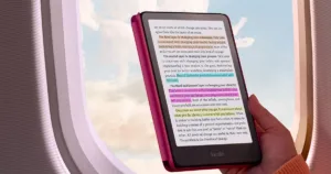 Kindle Colorsoft being read on a plane, with colourful highlights across the page