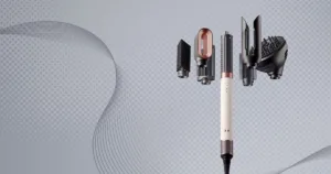 Dyson airwrap co-anda 2x with attachments, floating on a grey background