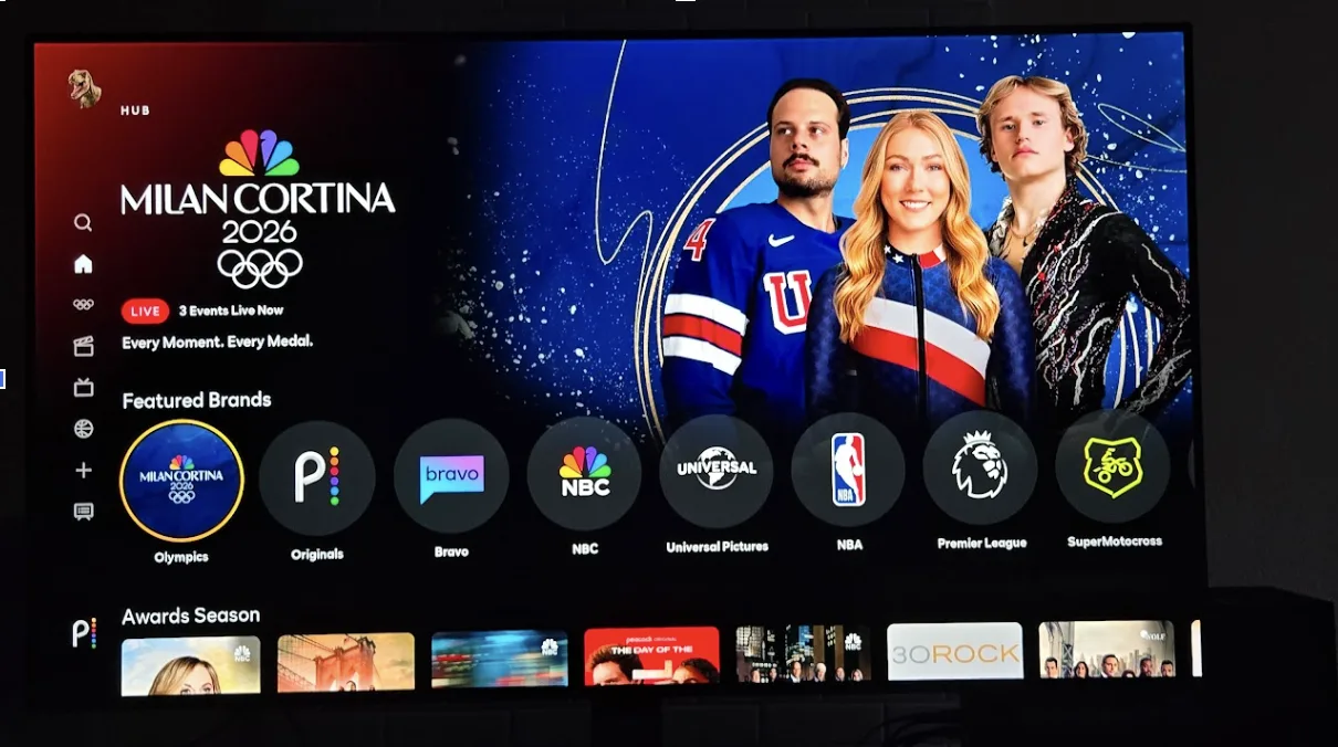 Peacock's home screen displayed on a TV, showing a Milan Cortina 2026 Olympics banner with three athletes in Team USA gear and a "3 Events Live Now" indicator.