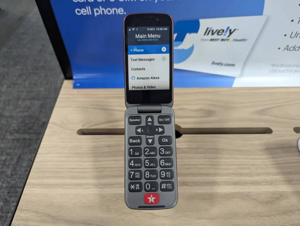 A Lively flip phone is displayed on a Best Buy store counter.