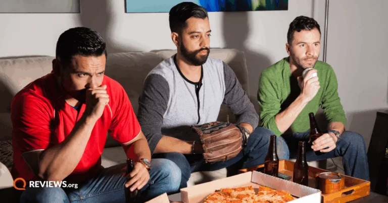 3 men watching baseball