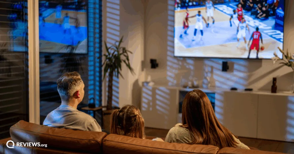 Family watching basketball game. Image Credit: iStock/simonkr