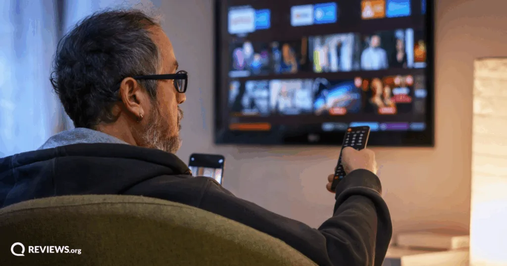 Man with remote control finding what to watch. Image Credit: iStock/ugurhan