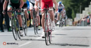 Group of cyclists competing in a road race during the Tour de France, photographed from a low angle on the course.