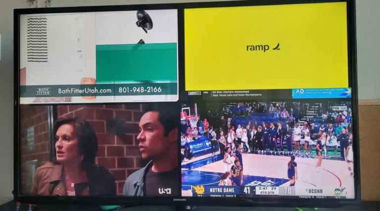 Photo of a Samsung TV displaying YouTube TV's multiview feature with four channels visible at once, including a college basketball game between Notre Dame and UConn, a USA Network drama, and two other feeds.