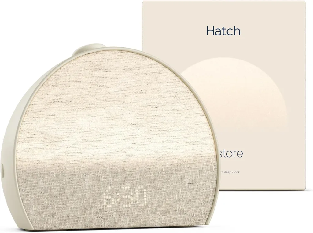 Hatch Restore 3 sunrise alarm clock and sound machine on a nightstand