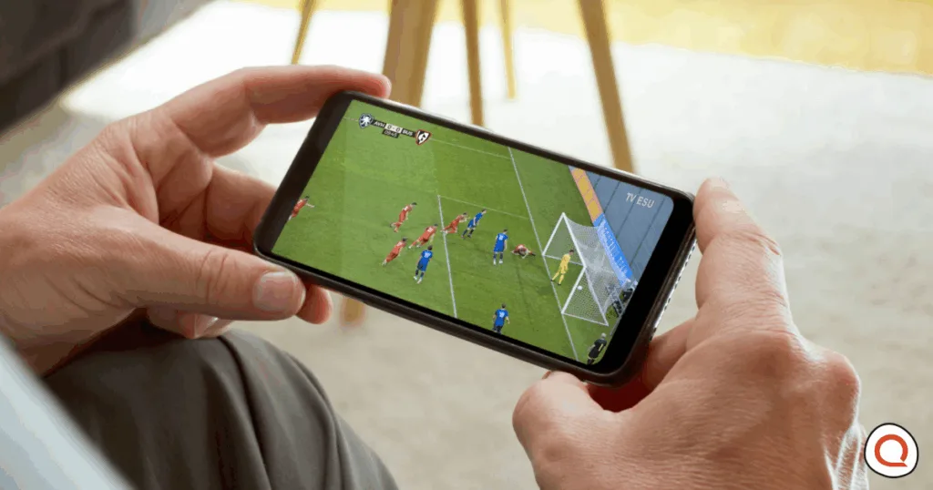 Person watching sports on a mobile device. Image credit: iStock/simonkr