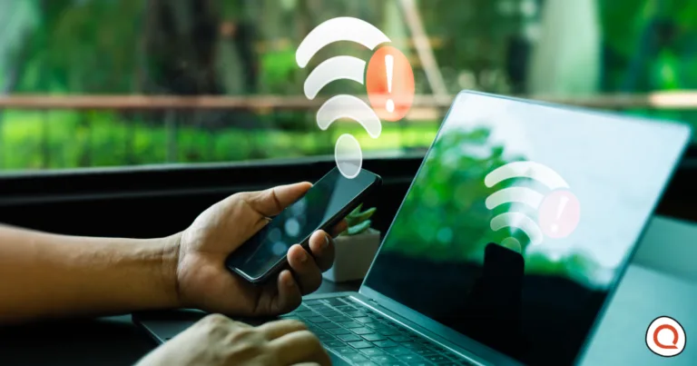 Person using smartphone and laptop showing Wi-Fi outage warning symbols during internet connection disruption