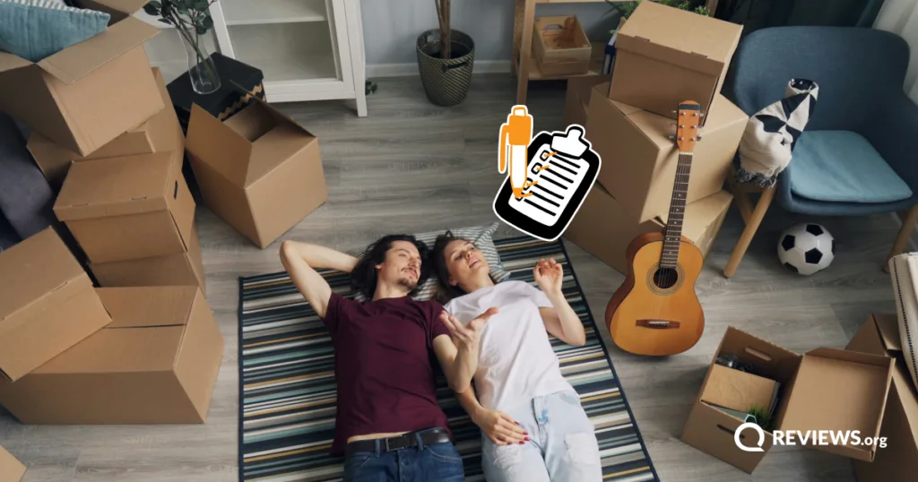 Couple lying on the floor surrounded by moving boxes with a moving checklist graphic overlay