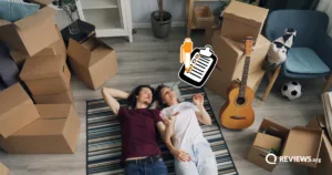 Couple lying on the floor surrounded by moving boxes with a moving checklist graphic overlay