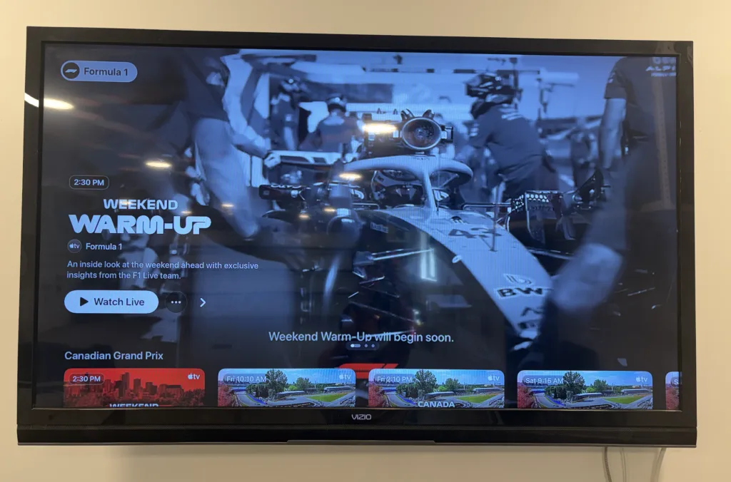 Apple TV app home screen showing Formula 1 Weekend Warm-Up and Canadian Grand Prix schedule tiles on a Vizio TV.