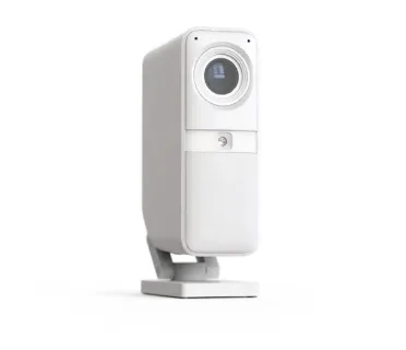 White SimpliSafe wireless indoor security camera on a small stand against a white background
