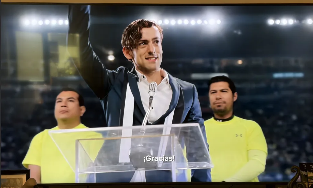 Spanish-language TV show playing on a large screen.