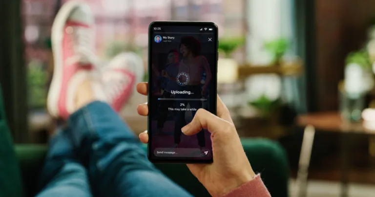 A person holding a phone showing a story upload stuck at 2%, illustrating slow social media upload speeds.
