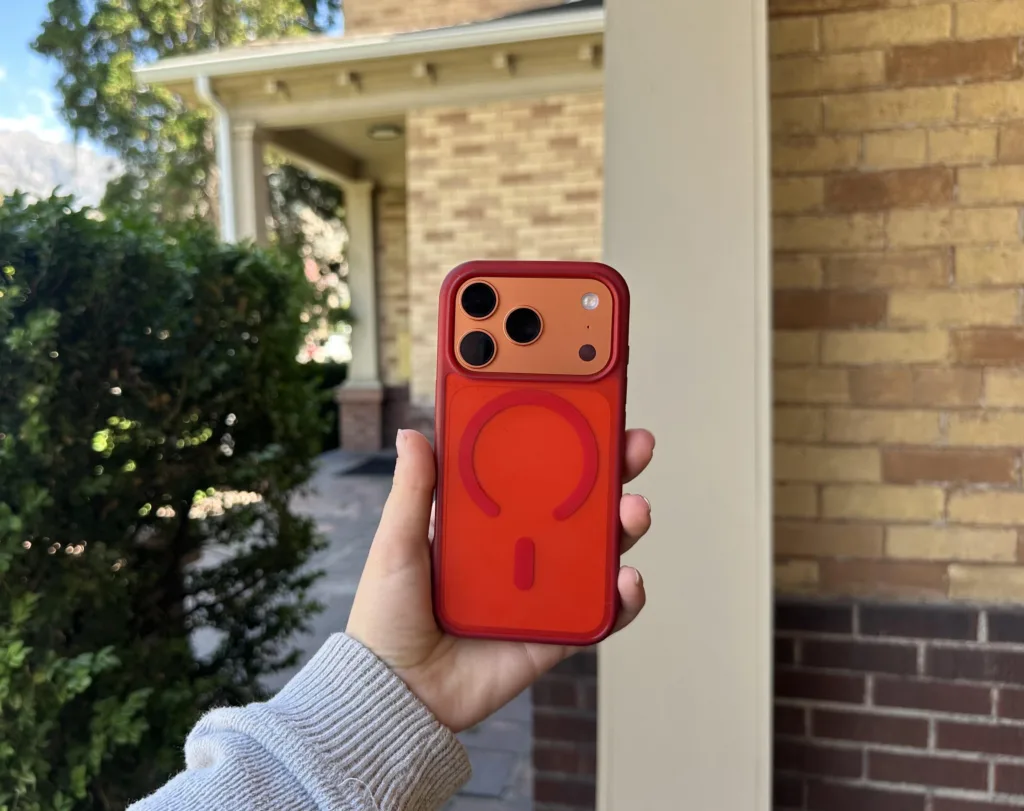 Orange iPhone 17 Pro with a red case received through the best iPhone deals with T-Mobile.