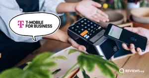 Customer paying by phone at a shop card reader, with a speech bubble showing the T-Mobile for Business logo.