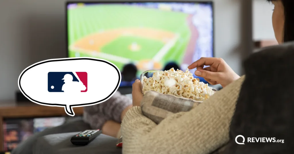 A person eats popcorn while watching an MLB game on TV, with the MLB logo highlighted in a speech bubble.