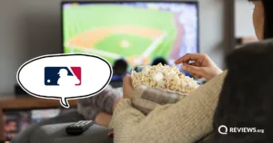 A person eats popcorn while watching an MLB game on TV, with the MLB logo highlighted in a speech bubble.