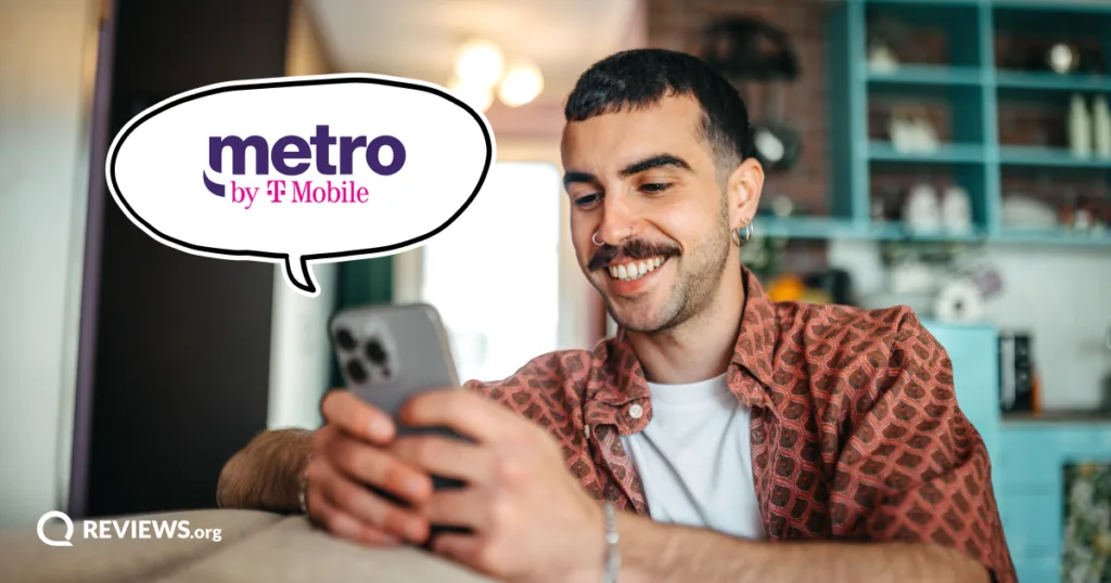 A smiling man scrolls on his phone beside the Metro by T-Mobile logo, enjoying the savings of a cheap unlimited phone plan.