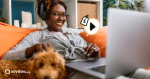Smiling woman with headphones streams on her laptop beside her dog, with a play button and price tag representing ways to stream for free.