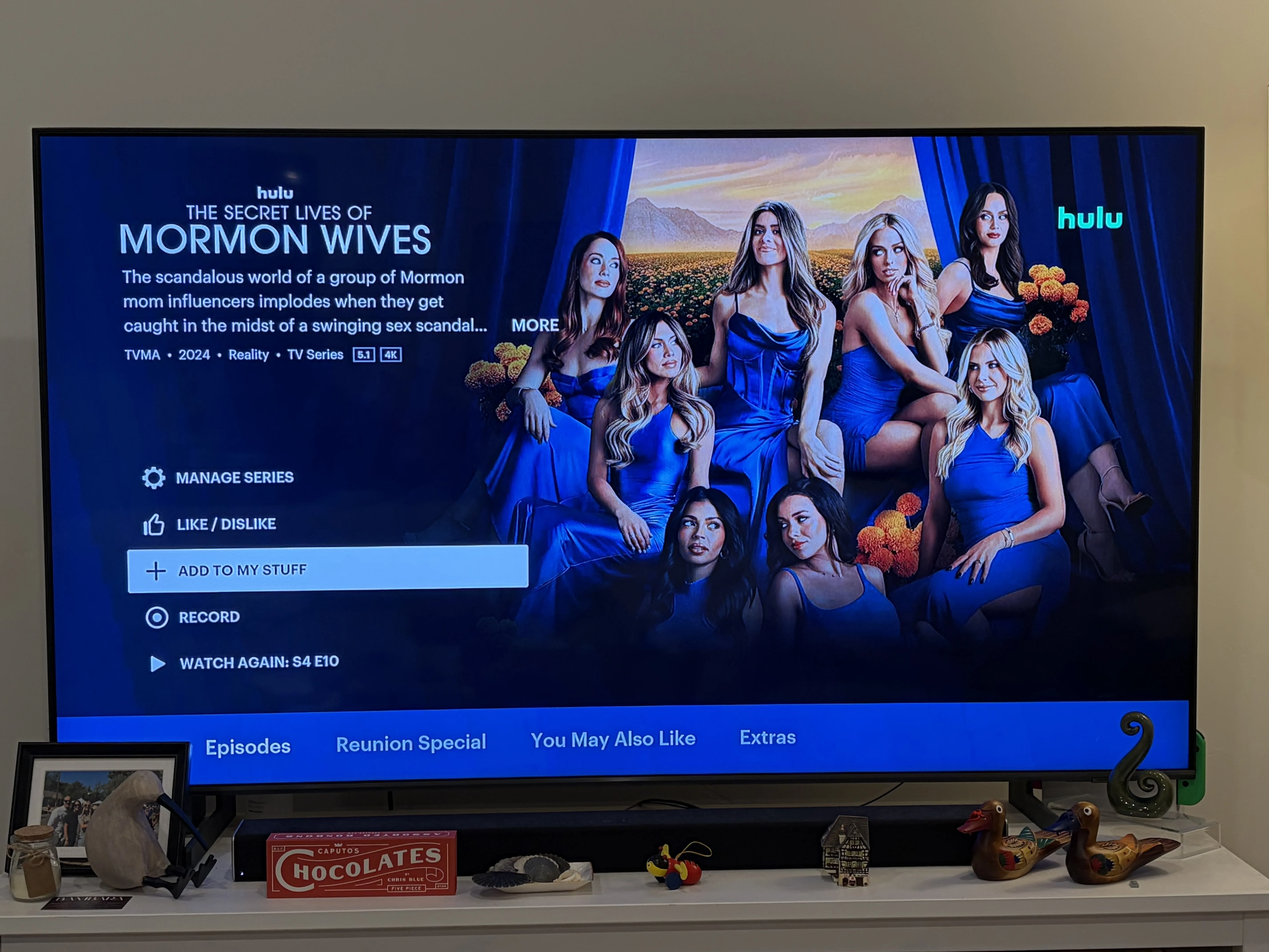 TV screen showing title screen for “The Secret Lives of Mormon Wives” Hulu reality TV show with multiple episodes and program listings.